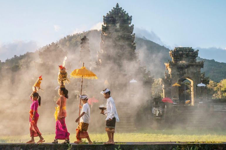 1 05 770 Bali traditional Balinese male and female ceremonial clothing and religious offerings shutterstock 1053593439