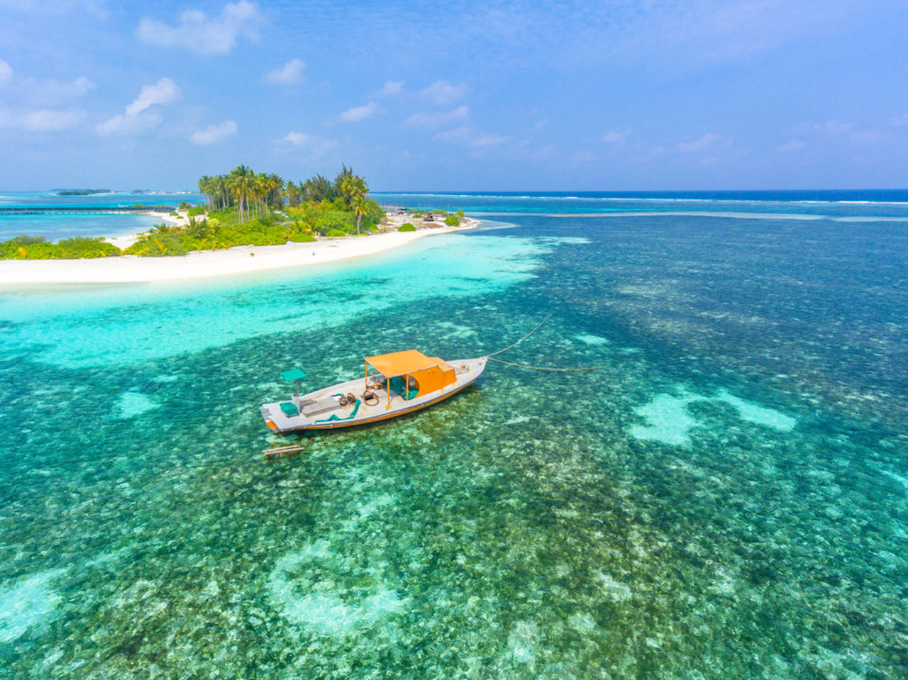1280 boat near tropical Olhuveli island shutterstock 1456705880